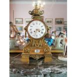 Good quality 19th. C. gilded bronze mantle clock surmounted with urn, lions masks and swags with