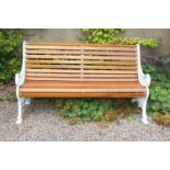 Decorative cast iron garden seat with wooden slats { 88cm H X 154cm W X 48cm D }.