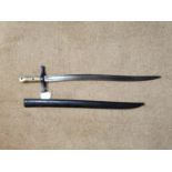 20th C. French bayonet in original scabbard with brass hilt {72 cm L}.