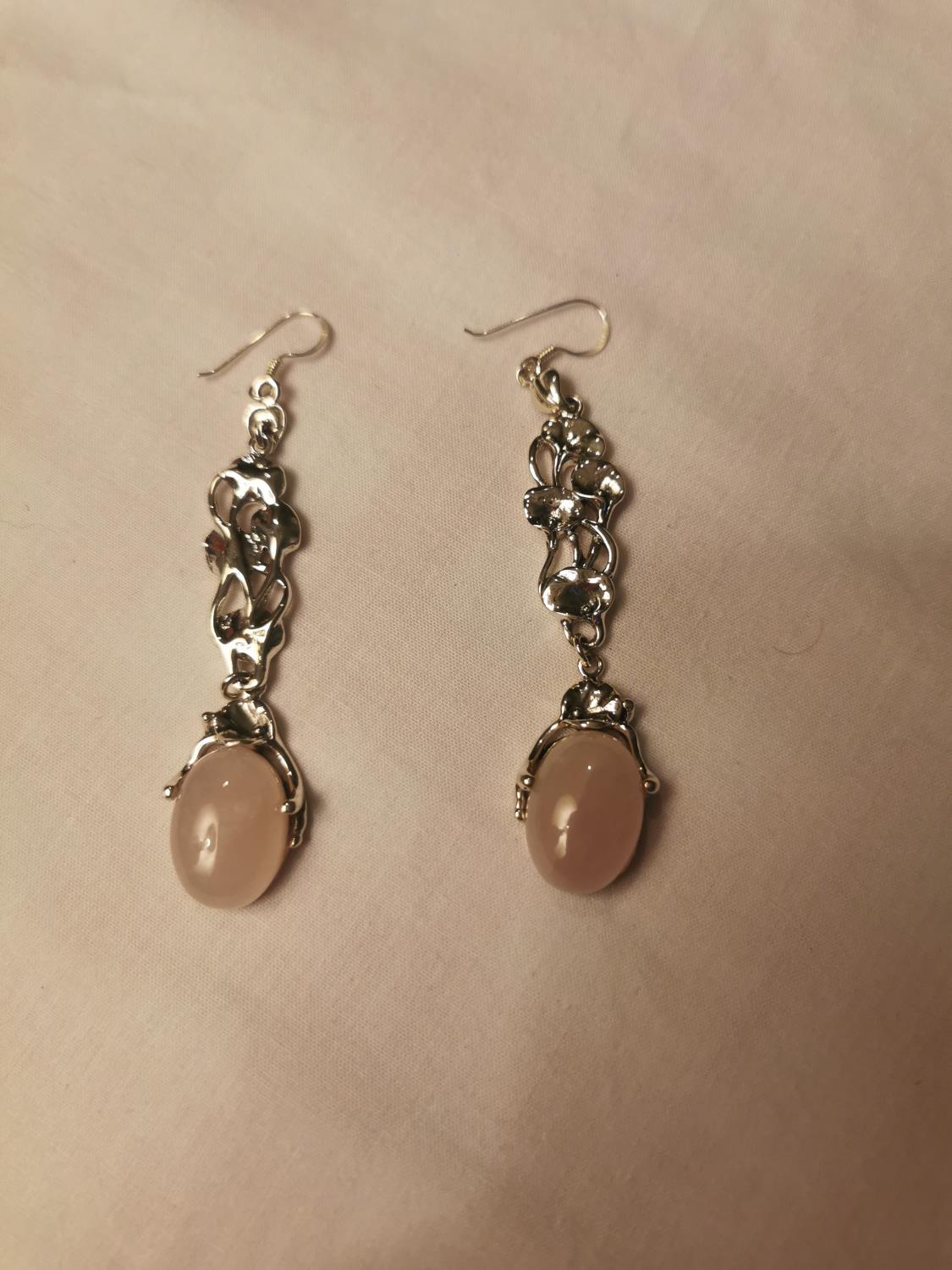 Pair of silver and rose quartz drop earrings.