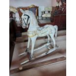 Carved wooden painted childs rocking horse {97 cm H x 104 cm W x 30 cm D}.