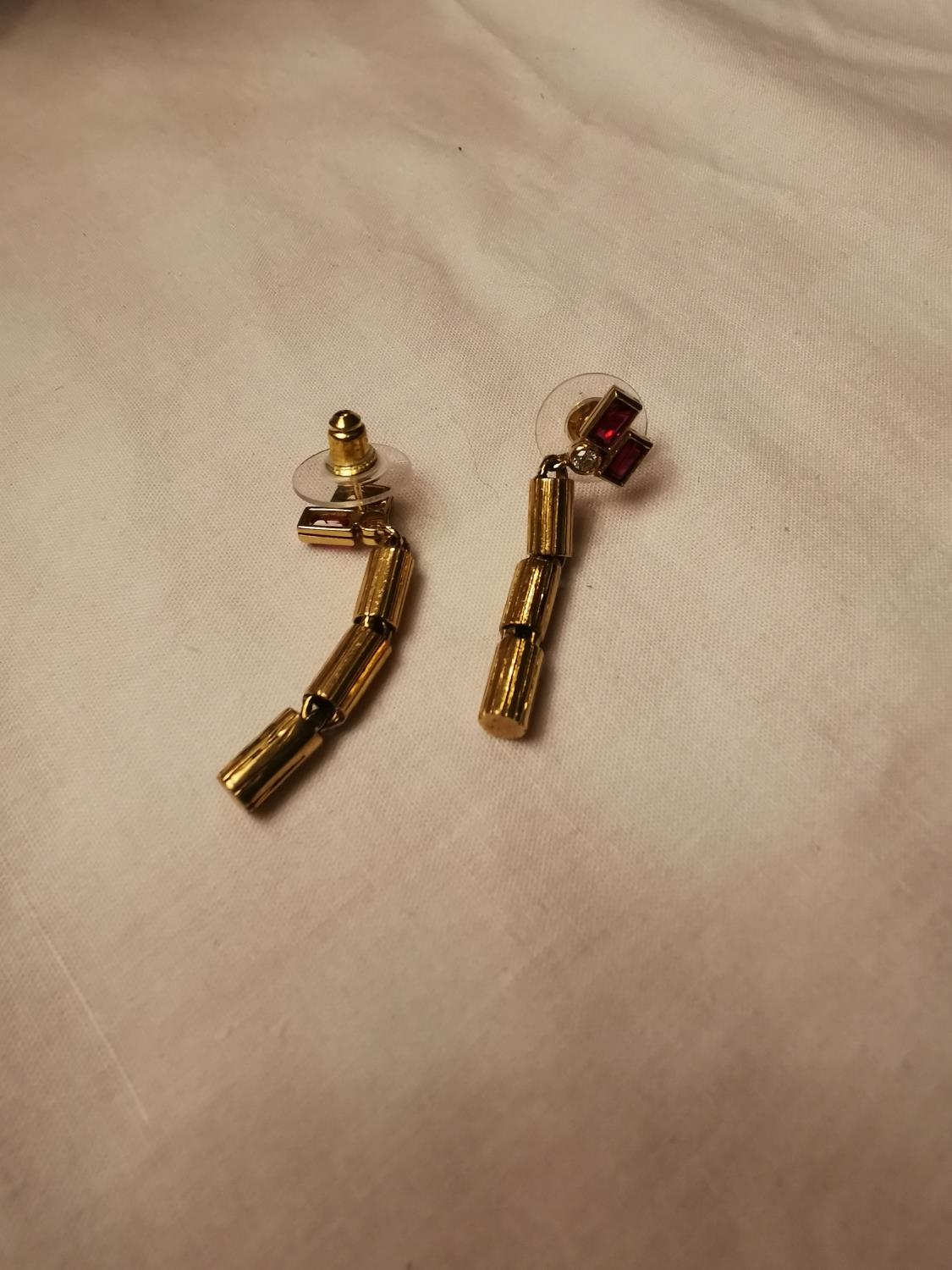 Pair of 14ct. yellow gold ruby and diamond drop earrings in the Art Deco style.