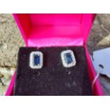 Pair of 18ct. White gold sapphire and diamond earrings. Estimated: weight of diamonds 82points / .