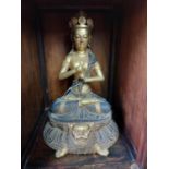 Oriental gilded metal Buddha seated on a Lotus Flower throne. {37 cm H x 22 cm W x 20 cm D}.