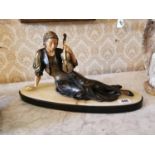 Painted bronze figure of a seated Musician on marble base in the Art Deco style {33 cm H x 55 cm W x