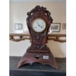 19th C. carved walnut mantle clock with enamel dial {54 cm H x 37 cm W x 20 cm D}.