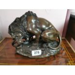 Bronze model of a crouching lion {23 cm H x 26 cm W x 16 cm D}.