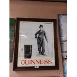 Charlie Chaplin Guinness framed advertising print. {64 cm H x 53 cm W}.