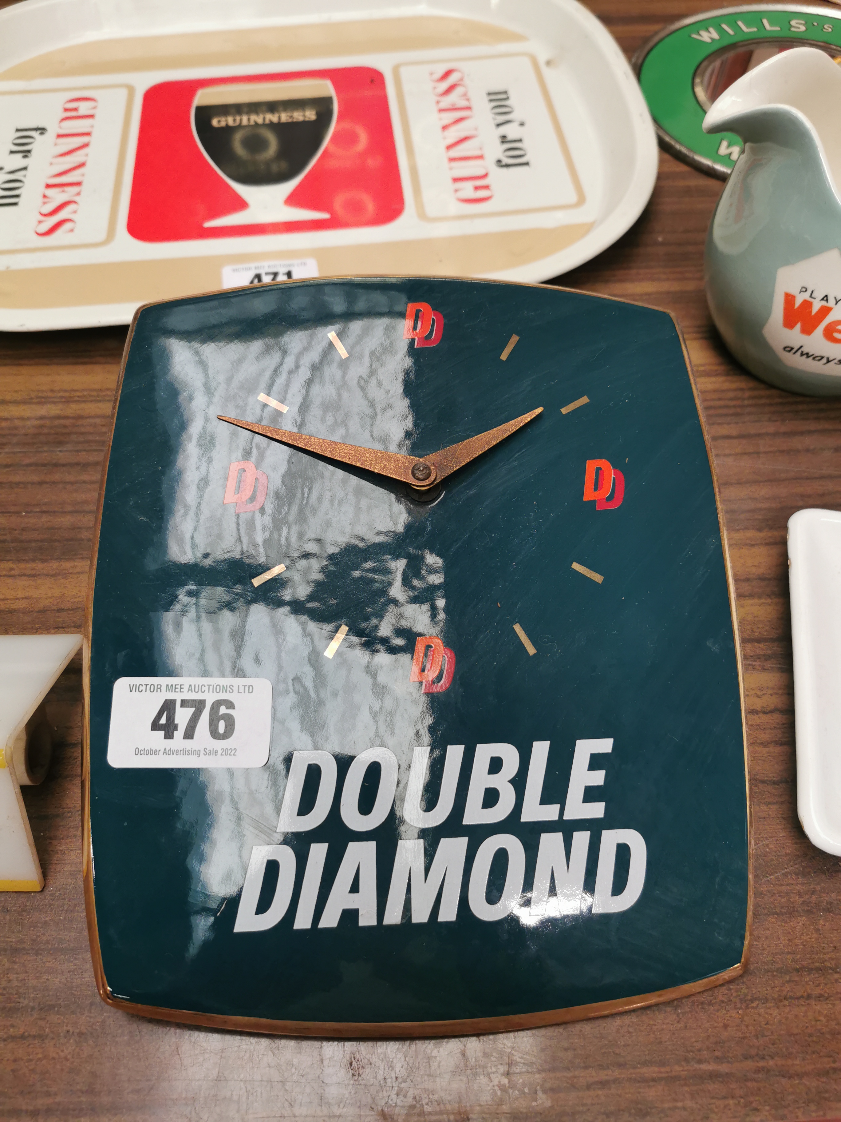 Double Diamond ceramic advertising clock { 23cm H X 20cm W }.