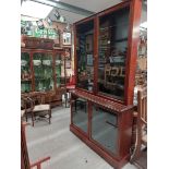 Early 20th mahogany shop display cabinet with two glazed doors over two glazed doors. {217 cm H x
