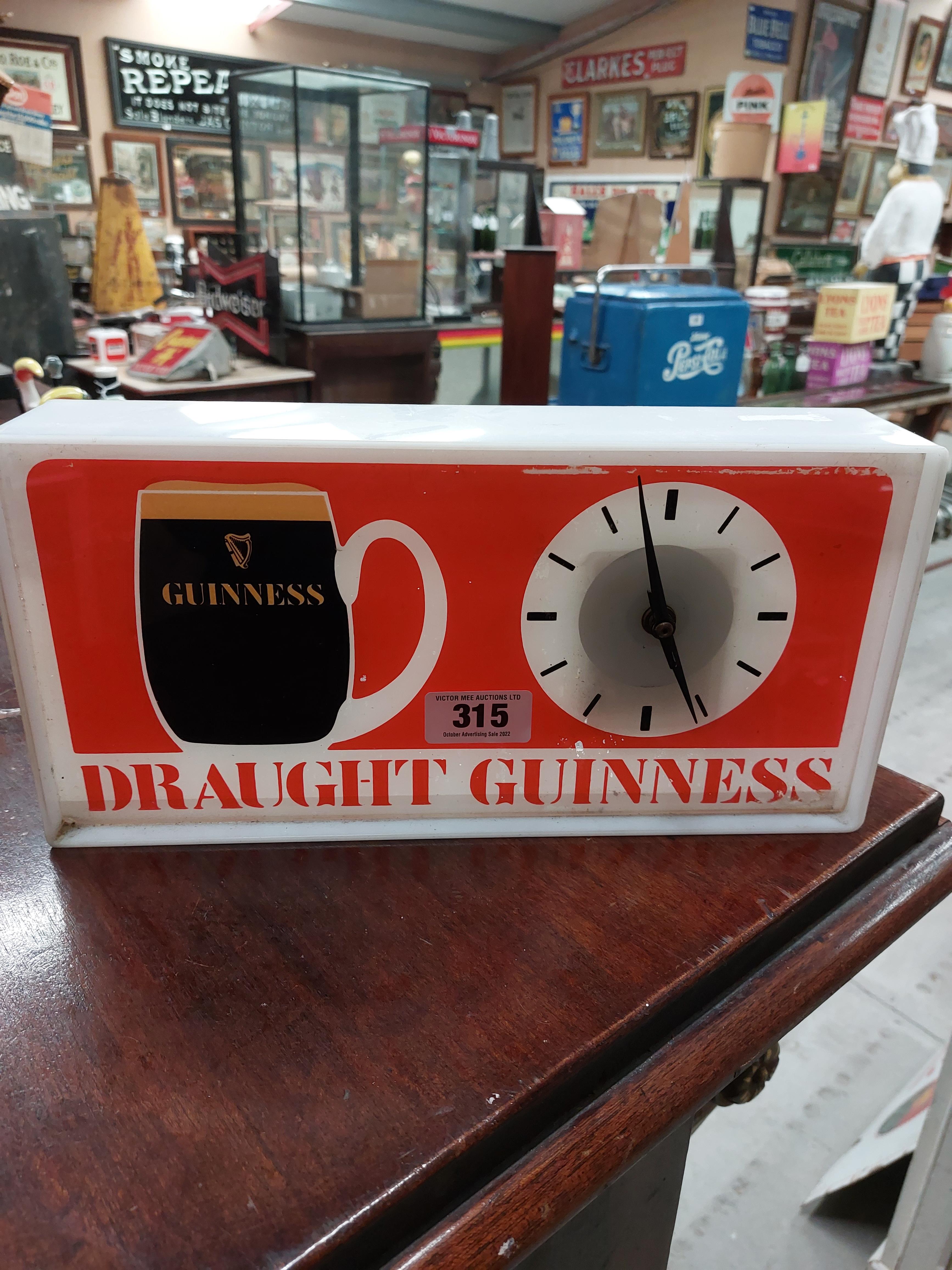 Perspex Draught Guinness light up advertising clock { 18 cm H x 36 cm W x 7 cm D}.