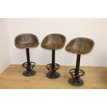 Set of three cast iron swivel tractor seat stools { 100cm H X 53cm W X 44cm D }.