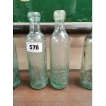 Two early 20th C. glass bottles - R Perry and Son Ltd Rathdowney and M Sullivan Waterford. {22 cm