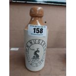 M Nugent Essex St Dublin stoneware Ginger beer bottle. { 18 cm H x 7 cm Dia}.