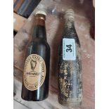 Two wooden Guinness bottles in the form of brushes. {20 cm H x 6 cm W}.