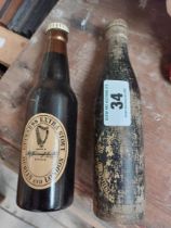 Two wooden Guinness bottles in the form of brushes. {20 cm H x 6 cm W}.