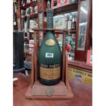 Remy Martin Brandy Bottle in wooden cradle. {52 cm H x 18 cm W x 19 cm D}.