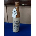 G J Hassett Ennis stoneware Ginger beer bottle. { 20 cm H x 7 cm Dia}.