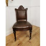 Edwardian carved oak and leather upholstered side chair with amorial crest raised on tapered legs