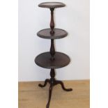 Mahogany three tier dumb waiter raised on three outswept legs { 102cm H X 38cm Dia }.