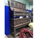 19th C. ornately carved oak side board the canopy top above two panelled doors and open shelf