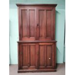 19th. C. stained pine estate cupboard with two panelled doors over two panelled doors raised on