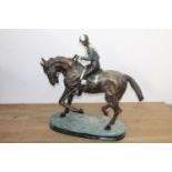 Bronze model of a horse and jockey { 102cm H X 38cm W X 104cm D }..