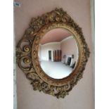 Decorative carved giltwood convex wall mirror in the 19th. C. style {85 cm Dia.}.