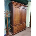 19th C. Mahogany Linen Press with two arch panel doors over two long drawers raised on plinth