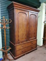 19th C. Mahogany Linen Press with two arch panel doors over two long drawers raised on plinth