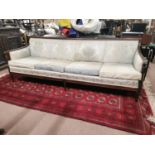 20th. C. upholstered mahogany four seater couch raised on turned legs in the Regency style { 82cm
