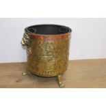 19th. C. beaten brass and copper coal bucket decorated with lion's mask and raised on lion's paw