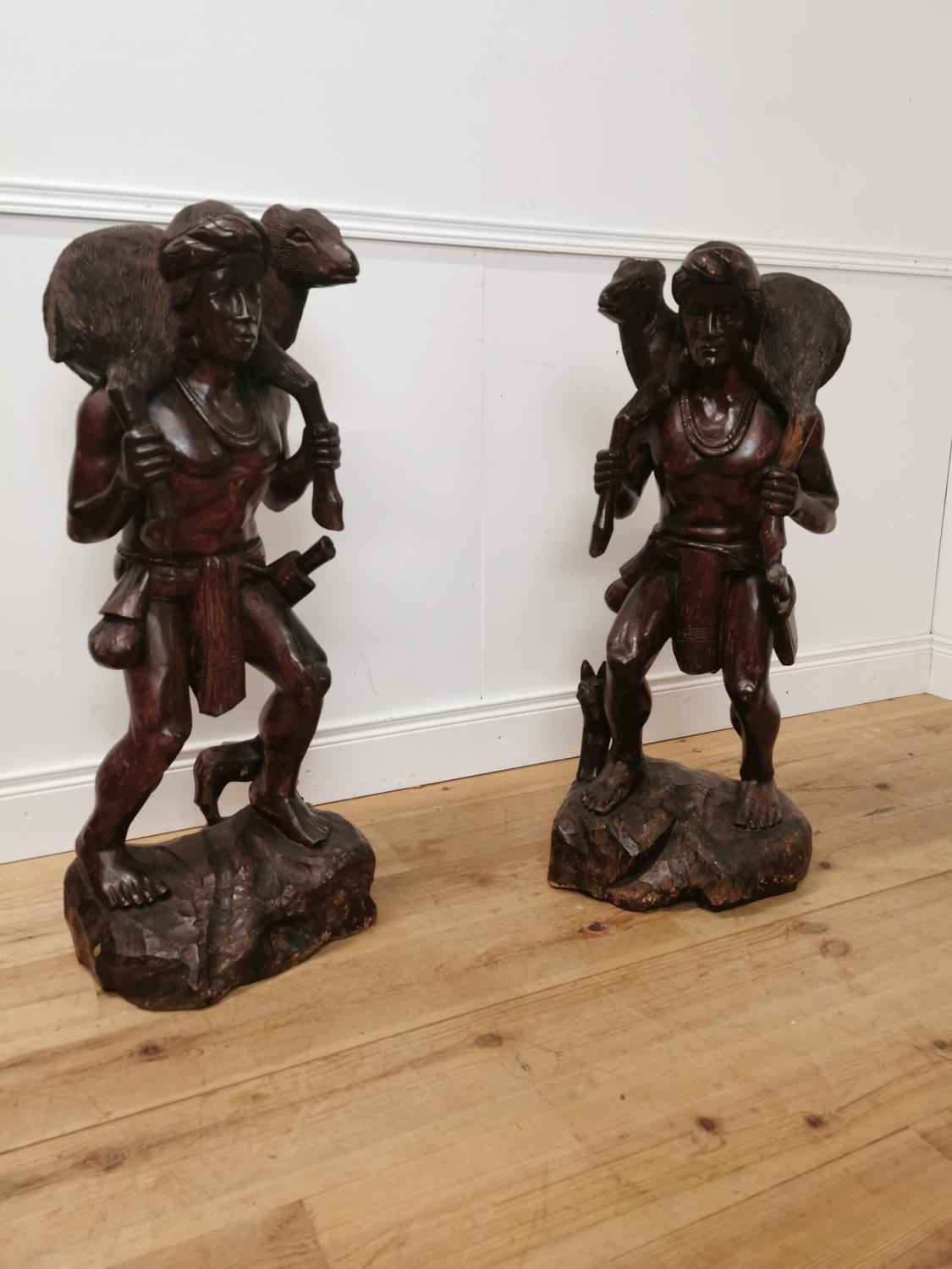 Pair of carved hardwood figures of Hunters. { 10cm H X 36cm W X 30cm D }.