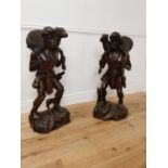 Pair of carved hardwood figures of Hunters. { 10cm H X 36cm W X 30cm D }.