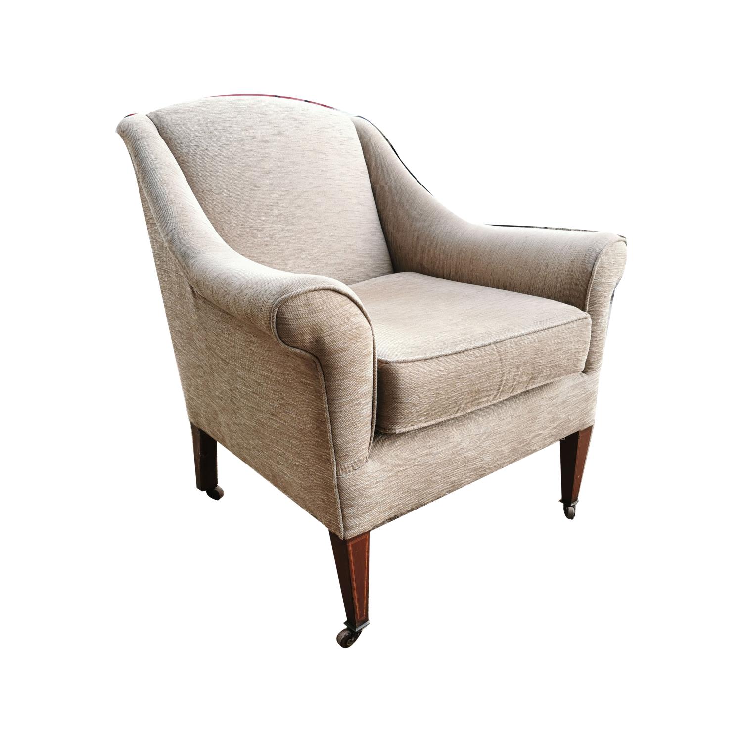 Edwardian upholstered inlaid mahogany armchair raised on tapered square legs with brass casters {