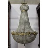 Cut glass and brass six lamp chandelier decorated with floral and mask motifs { 80cm H X 40cm Dia }.