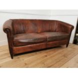 Early 20th. C. French hand dyed cigar leather upholstered two seater couch raised on tapered