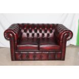 Deep buttoned leather upholstered two seater Chesterfield couch { 75cm H X 148cm W X 87cm D }.