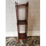 Walnut three tiered whatnot on turned supports {131 cm H x 31 cm W x 31 cm D}.