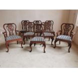 Set of six plus two carved mahogany dining room chairs with upholstered seats raised on cabriole