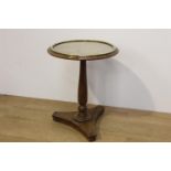 Oak wine table the top with brass band enclosing a glass plate raised on tapered column and platform