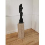 Model of Lady in polished black marble on cream marble polished plinth. {145 cm H x 25 cm W x 25