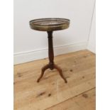 Mahogany wine table the brass gallery above a marble top on turned reeded column and three