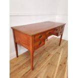 Edwardian satinwood and inlaid desk with central drawer flanked by four short drawers on tapered