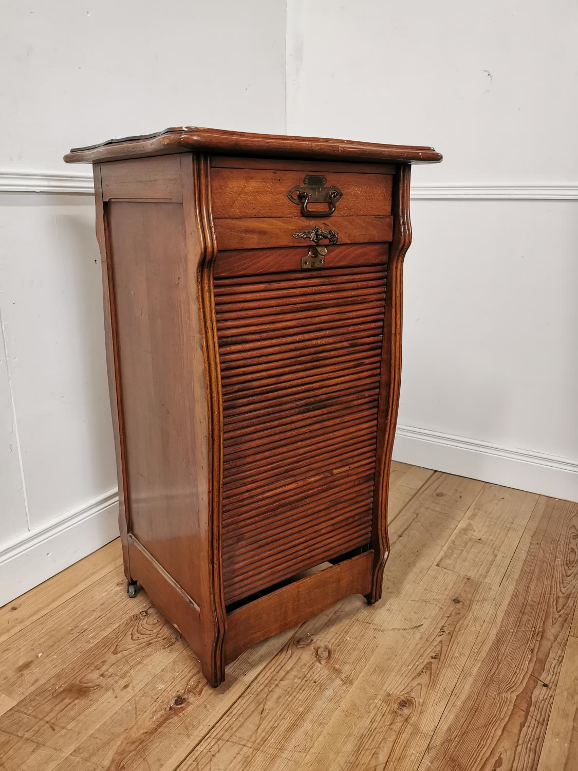 Early 20th. C. oak tambour cabinet with single short drawers above the tambour door enclosing