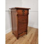 Early 20th. C. oak tambour cabinet with single short drawers above the tambour door enclosing