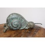Bronze model of a baby in a snail shell { 25cm H X 62cm W X 17cm D }.