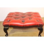 Deep buttoned leather upholstered foot stool raised on Queeen Ann legs { 30cm H X 66cm W X 48cm D }.