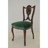 Carved mahogany side chair with upholstered seat raised on Queen Ann legs .