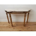 Giltwood consul table the marble top above an open work frieze raised on turned tapered legs {